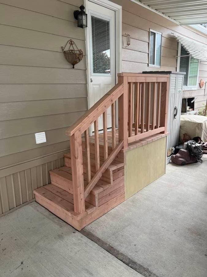 picture of newly remodeled wood staircase leading to the side of a home