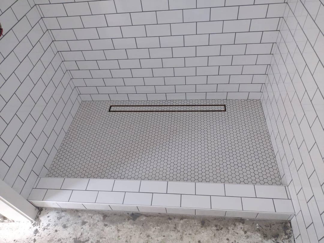 newly remodeled bathroom with custom tiles on the floor and walls 